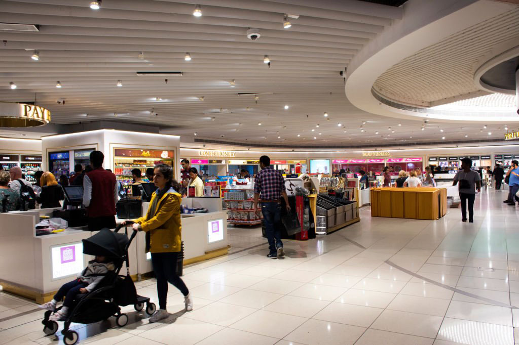 Indian people and foreign travelers walking waiting and shopping in shop inside of Indira Gandhi International Airport at Delhi city on March 24, 2019 in New Delhi, India